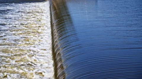 The flow of water from the outlet of an artificial dam Stock Footage 241661644