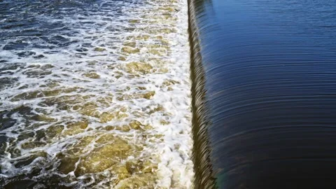 The flow of water from the outlet of an artificial dam Stock Footage 241662456