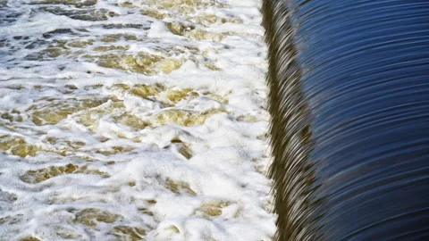 The flow of water from the outlet of an artificial dam Stock Footage 241663277