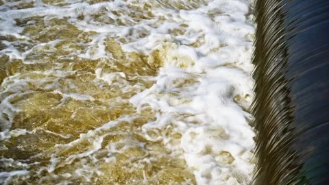 The flow of water from the outlet of an artificial dam Stock Footage 241663664