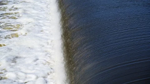 The flow of water from the outlet of an artificial dam Stock Footage 241666482