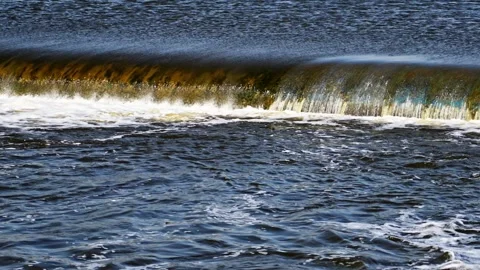 The flow of water from the outlet of an artificial dam Stock Footage 241666876