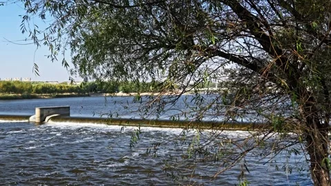 The flow of water from the outlet of an artificial dam Stock Footage 241667115