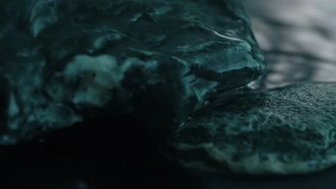 The flow of water over the dark stones. Stock Footage 273572691
