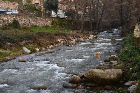 Flow of water from a river passing through a town Stock Photos
