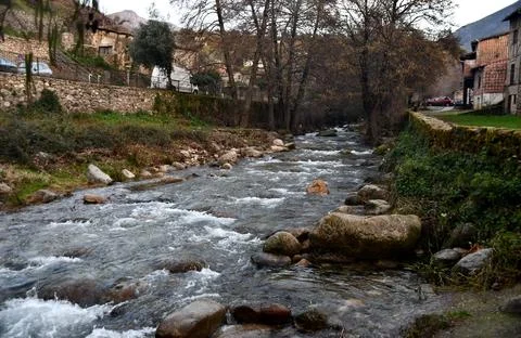 Flow of water from a river passing through a town Stock Photos