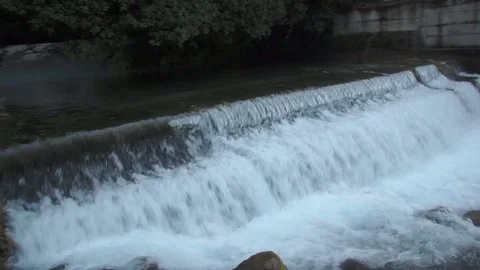 This is the flow of water of a small mountain river with a cascade of waterfalls Stock Footage 165495405