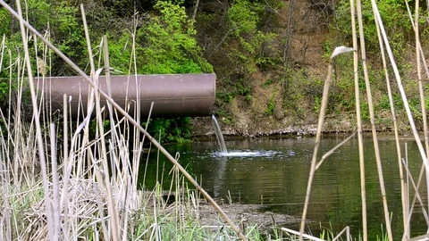The flow of water spilling from the pipe Stock Footage 75469038