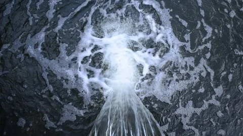 The flow of water spilling from the pipe in the water Stock Footage 75521337
