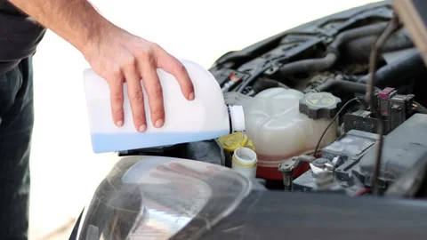 Flow windshield fluid into the car windshield washer reservoir Stock-Footage 210231858