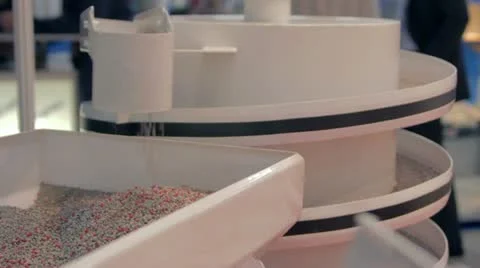 Flowable material pours from shaking conveyer Stock Footage 12180318