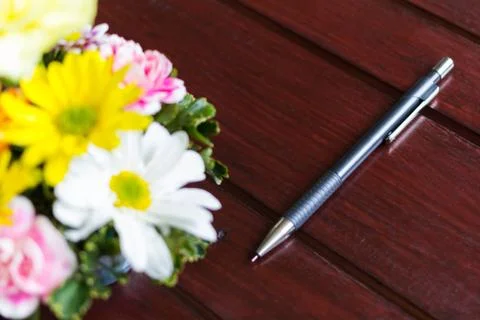 Flower and pencil  on the table Stock Photos