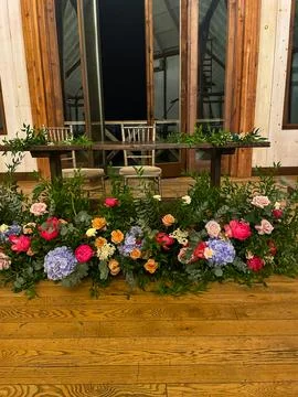 A flower arrangement below the head table Stock Photos