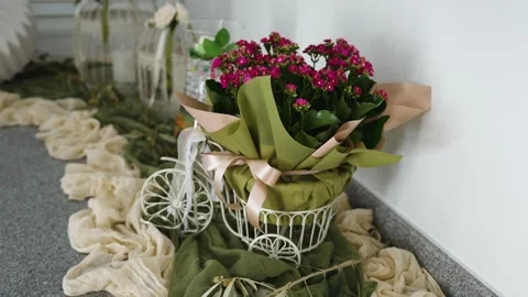 Flower arrangement on a table with decorative items in a home setting Stock Footage 334979862