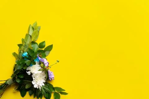 Flower arrangement on top on a yellow background Stock Photos