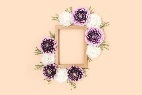 Flower border frame made of dahlia on a beige background. Stock Photos