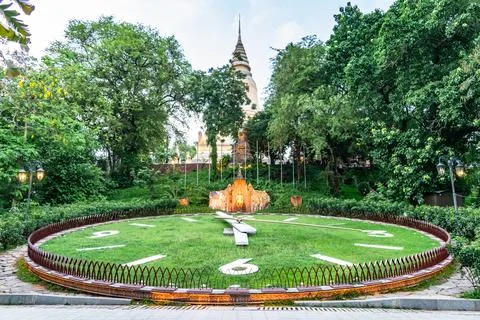Flower clock showing time and wat phnom in background in phnom penh, cambodia Stock Photos
