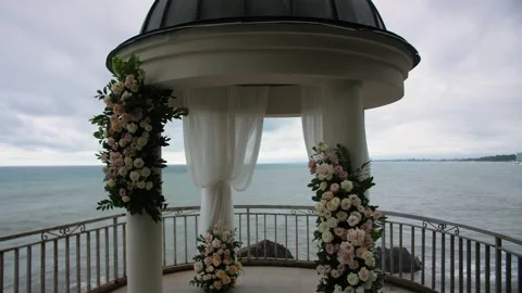 Flower-decorated wedding rotunda on the background of the sea Stock Footage 297604010