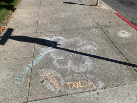 A Flower Drawn on a Sidewalk in Downtown Martinez, California with Names of Breo Stock Photos