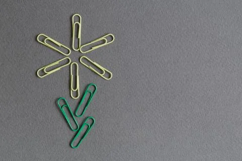 Flower made of colored paper clips. Office work concept. Stock Photos
