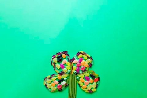 Flower made of sweets on a green background Stock Photos