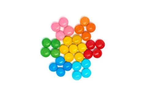 Flower of many colored small round candies isolated on a white background Stock Photos