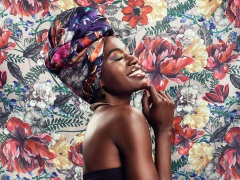 Flower pattern, head wrap and black woman with a smile, beauty and confident Stock Photos