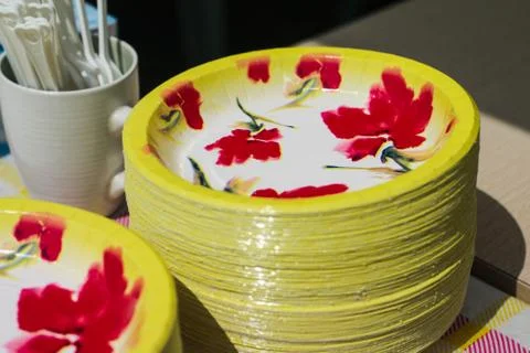 Flower pattern yellow plate stacked and white mug on the table. Stock-Fotos