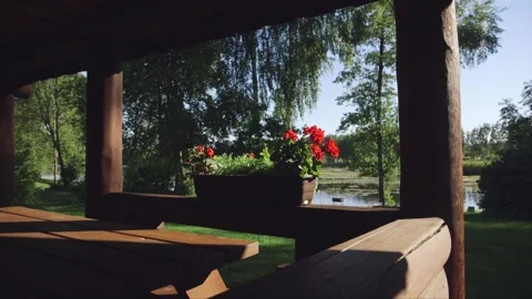 Flower pot on the edge of a fabulous log cabin patio Stock Footage 238776402