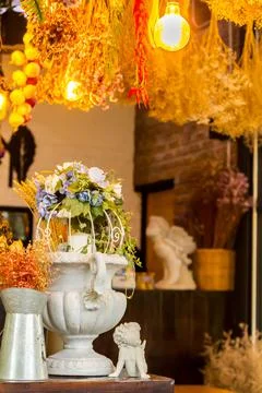 Flower pot style Gothic on table with dry flower bouquet. Stock Photos