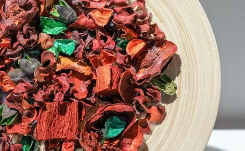 Flower sachet of multi-colored dried flowers on a wooden plate. Stock Photos