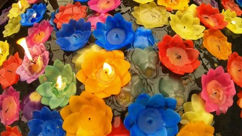 Flower shape candle floating on water in temple Stock Footage 97914197