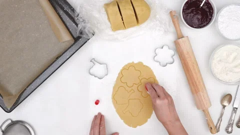 Flower shaped shortbread cookies filled with raspberry jam recipe. Stock Footage 146303386