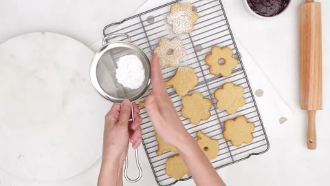 Flower shaped shortbread cookies filled with raspberry jam recipe. Stock Footage 146330677