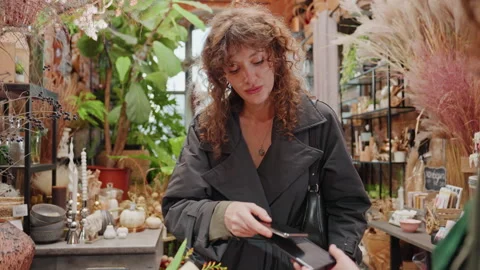 Flower shop interaction. Engaging with clients over colorful floral arrangements Stock Footage 330036050
