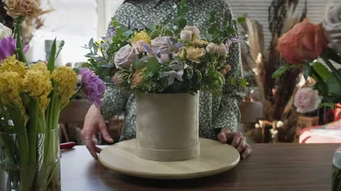 Flower shop worker shows large bouquet of roses and green branches Stock Footage 194725391