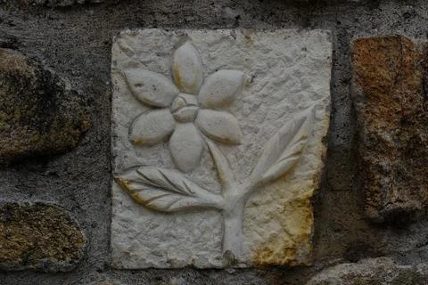 A flower on a stone bas-relief Stock Photos