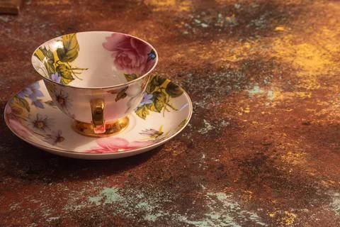 Flowered tea cup with colored background Stock Photos