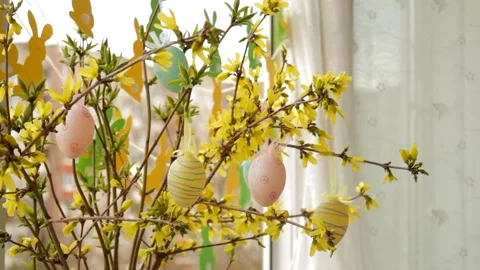 Flowering branches decorated with Easter eggs stand on the open window. Stock Footage 235173697