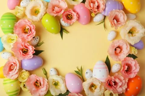 Flowers and Easter eggs on a colored background close-up. Easter background Stock Photos