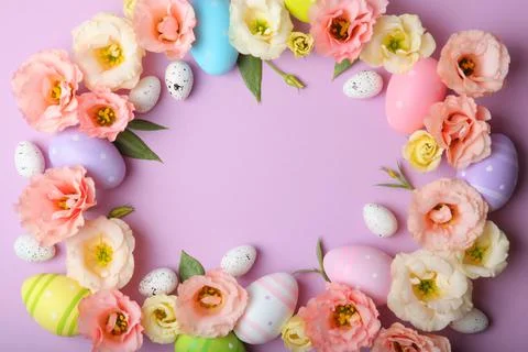 Flowers and Easter eggs on a colored background close-up. Easter background Stock Photos