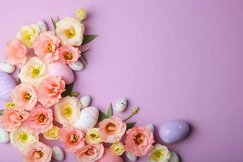 Flowers and Easter eggs on a colored background close-up. Easter background Stock Photos