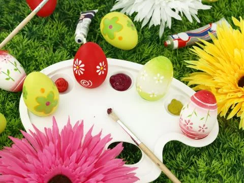 Flowers and Easter eggs on palette Stock Photos