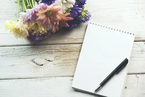 Flowers and notepad Stock Photos