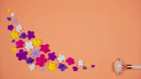 Flowers appear after Quartz Roller Facial Massager. Blooming beauty concept Stock Footage 170835076