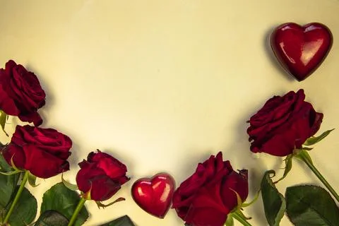 Flowers composition. Frame made of rose flowers and red heart on yellow Stock Photos