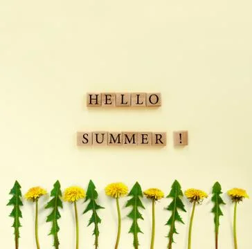 Flowers composition. Pattern made of yellow dandelions with leaves on beige p Stock Photos