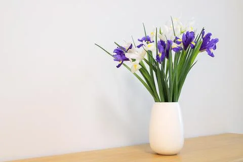 Flowers dutch iris in the vase on the table Stock Photos