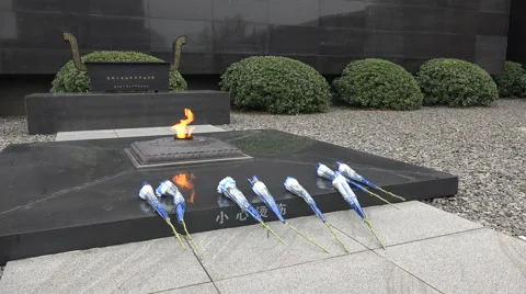 Flowers at eternal flame monument remembering Nanjing Massacre in China Video stock 60421864
