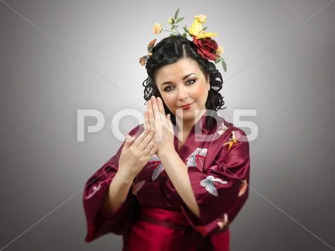 Flowers haired kimono woman showing traditional gestures Stock Photos